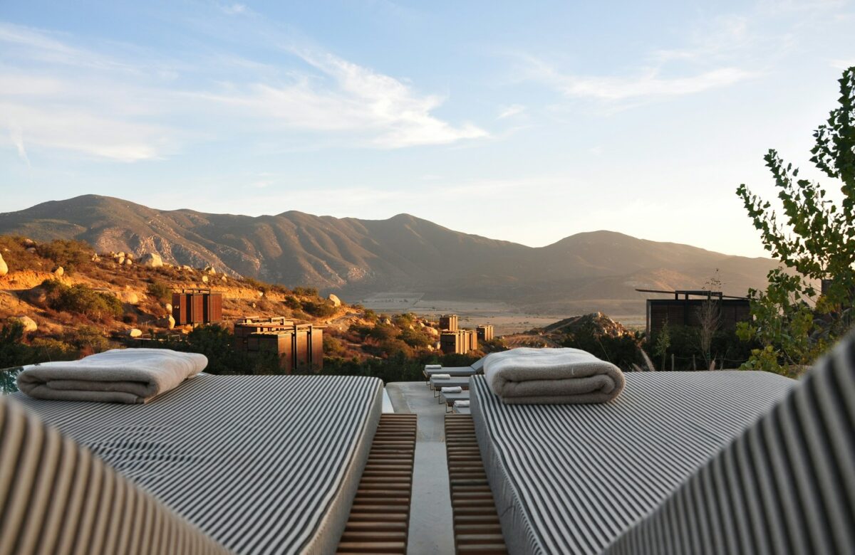 Luxury resort amenities available through best hotel loyalty programs, featuring poolside loungers with mountain views