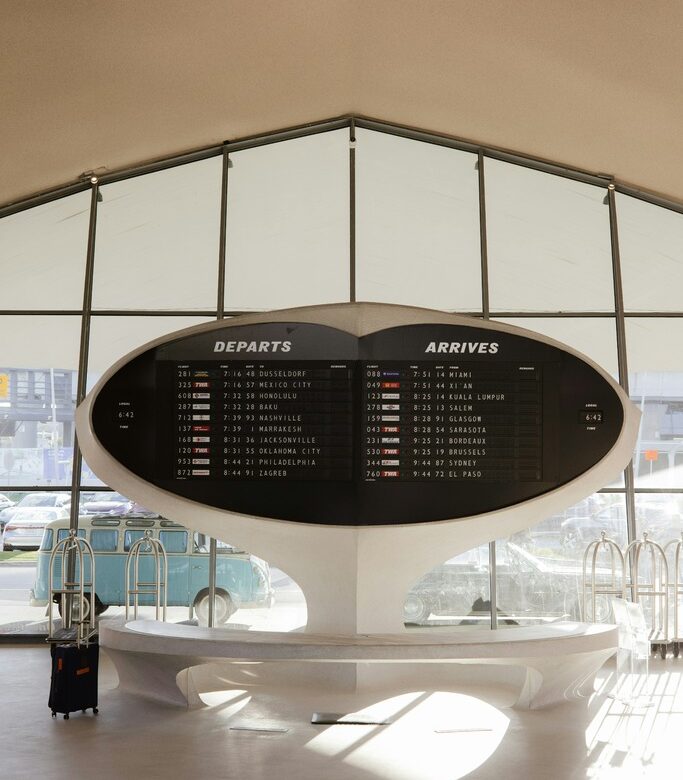 Airport departure board showing flight schedules at JFK airport for award booking planning